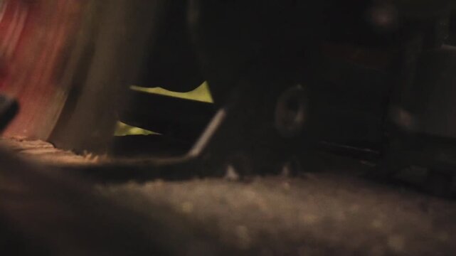 close up of circular saw cutting wooden plank