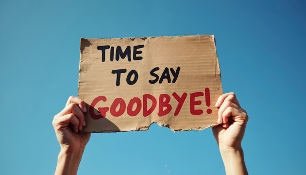 Hands hold cardboard sign saying Time To Say Goodbye against bright blue sky. Message indicates farewell, leaving or an end to something, suggesting a personal announcement.