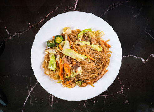 A traditional noodle dish made with rice noodles vegetables and meat stir fried to perfection