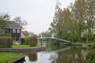 Fototapeta premium Traditional wooden footbridge over Dutch canal, Hindenloopen, Netherlands