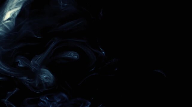 Smoke from cigarettes on a black background. Video close up