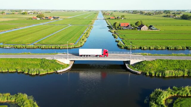 Truck Crossing Bridge Over Canal in Polder Landscape