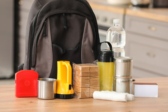Emergency backpack with necessities on table in kitchen