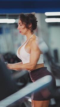 Muscular woman doing triceps pushdown exercise