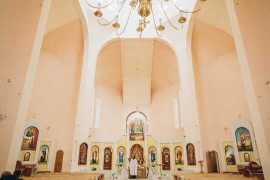 Priest performing religious ceremony inside christian church
