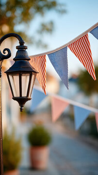 Festive street decoration with red and blue flag streamers on vintage lamp post for national celebration
