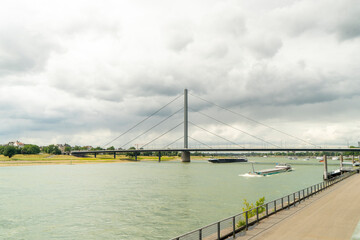 Fototapeta premium anoramic landscape of the Rhine riverfront featuring the cable-stayed Oberkassel bridge in Düsseldorf