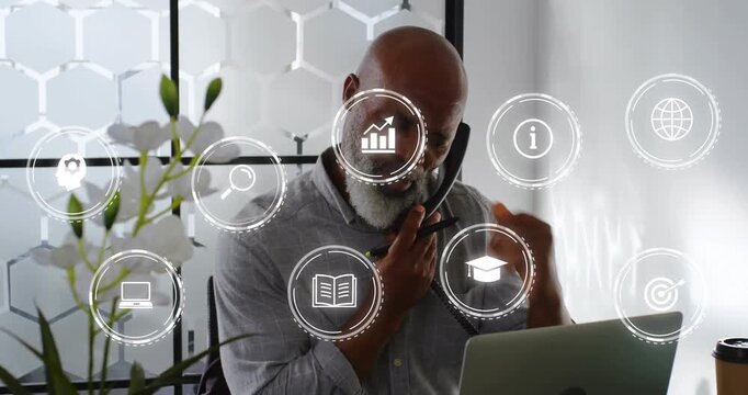 Man getting phone call, using laptop and noting for education as animated graph overlaying laptop