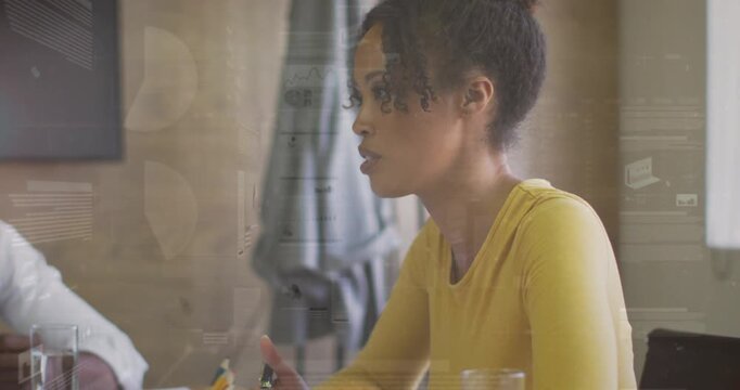 Woman referencing and reacting to business colleague prompt while animated charts overlaying papers