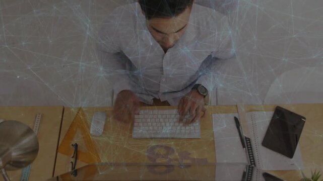 Man typing and clicking mouse at desk, keypress initiating web overlay mapping data for tech work