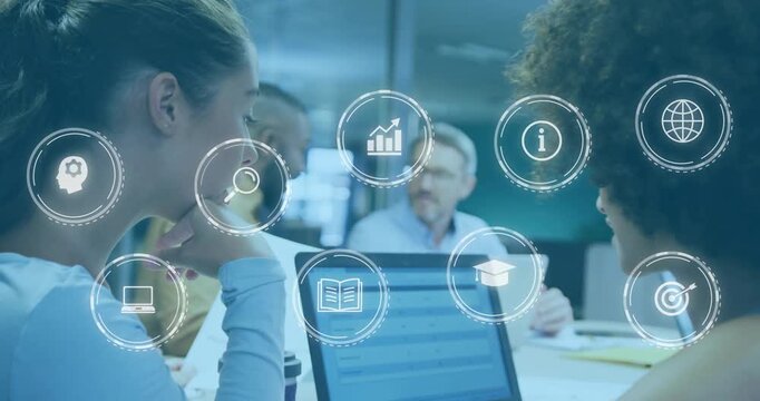 Two women viewing laptop in business meeting, single icon appearing, forming hologram grid