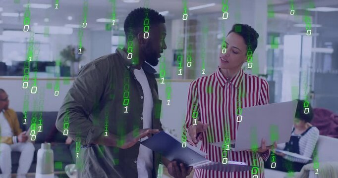 Office pair reviewing folder and laptop with woman pointing, working on tech as green code streams
