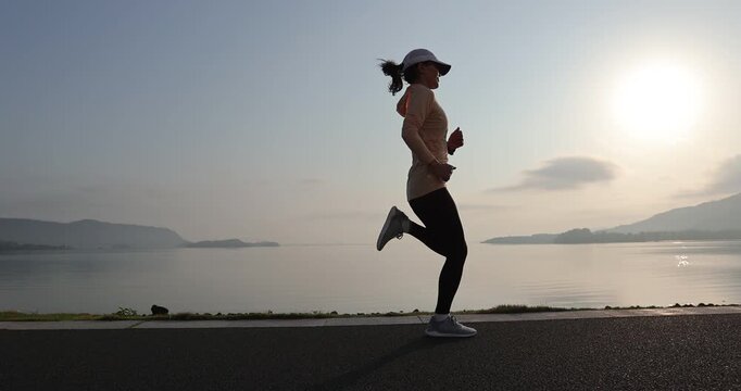 Fitness woman runner running at seaside