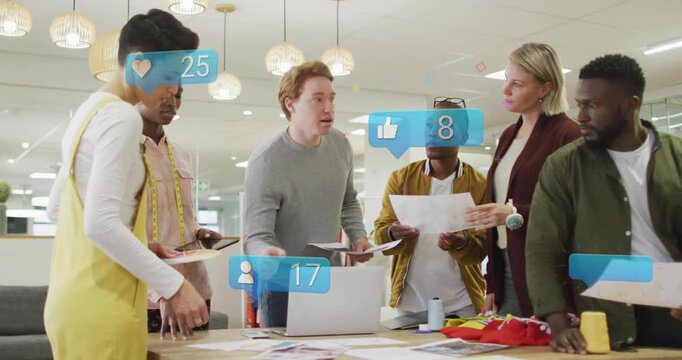 Red-haired man handing pages, team sorting designs, social icons updating above table for marketing
