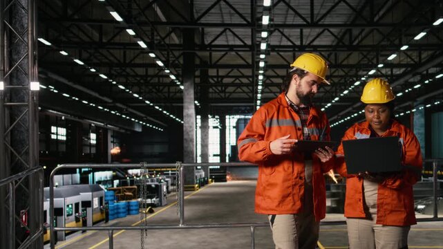 Diverse engineers coordinate operations across heavy industry production line, engineering plant. Overseeing operations with heavy equipment and industrial design for manufacturing workflow.