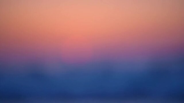 Blurry sunset over ocean waves.