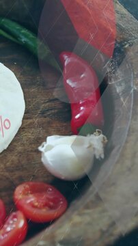 Vertical video: Overlay sweeping, camera panning right, revealing chiles, garlic, cheese for promo