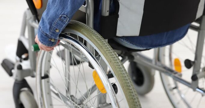 Woman using wheelchair at home, closeup view