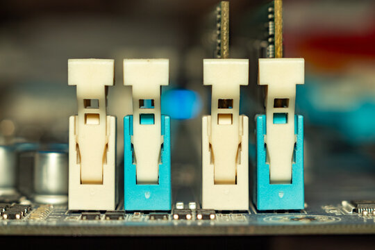 A detailed view of four sfp transceiver modules installed on a motherboard with blue connectors