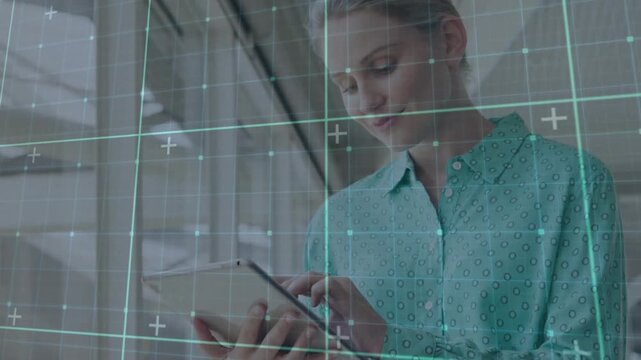 Vertical video: Woman tapping tablet in business lobby, activating cyan HUD grid and checking data