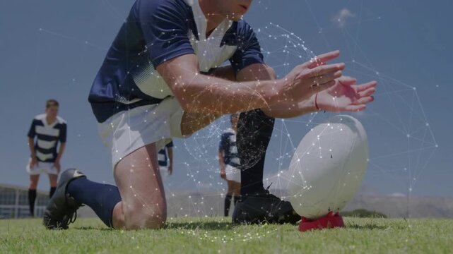 Rugby kicker placing ball on red tee, rising, running up aiming place-kick, particles circling ball