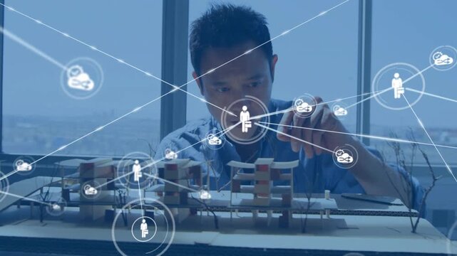 Architect studying model while center node emerging, network expanding and he adjusting pieces