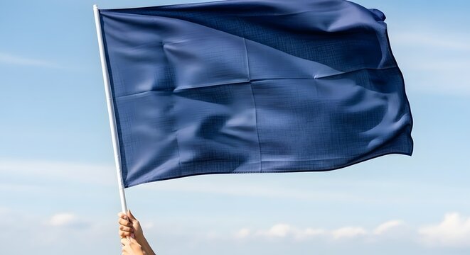 A hand holding a blue flag waving in the sky with clouds 2026 Commonwealth of Nations