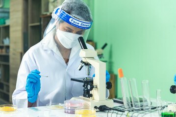 Fototapeta premium Scientist man holding chemical test glass tube testing science laboratory. Doctor clinic healthcare lab technician diagnosis sample. Asian man scientist working vaccine test medical biochemistry lab