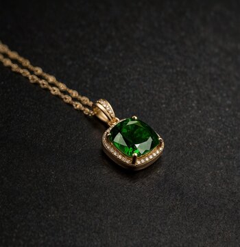 Cushion cut diopside  gemstone on gold necklace on plain black background