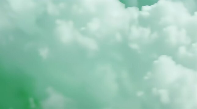 Dreamy white fluffy clouds gracefully drift across a soothing emerald green to pastel teal gradient background, providing a serene atmospheric texture for creative projects.