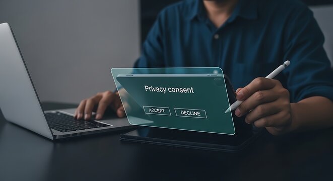 Man considering privacy consent options on a tablet while working at his laptop