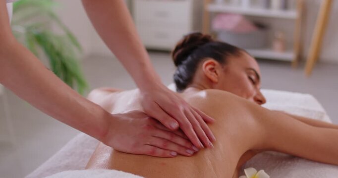 Aromatherapy and massage oils massage, woman enjoying relaxing aromas spa, natural aromatics oil pleasure, stimulating skin health, massage therapist doing soothing back massage, care to relax