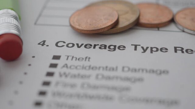 Coverage type request with coins on paper in focus