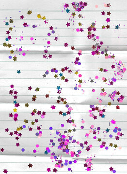lined folded paper letter with glitter sprinkled over the top 