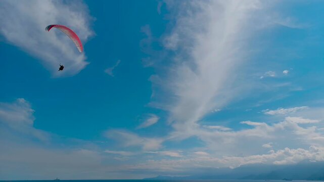 Paragliding silhouette flying in blue sky adventure sport travel concept