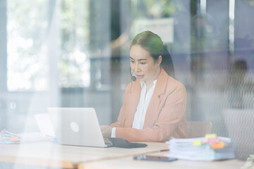 Fototapeta premium Customer Service Representative with Headset Assisting Client in Modern Office
