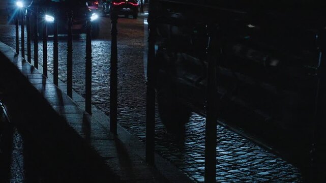 Cars on cobble stone road at night, Paris France, Europe