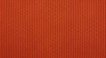 Fototapeta premium A close-up view of an orange fabric with a ribbed texture