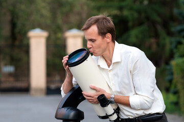 Man kisses telescope optical tube during astronomy session © Vagengeim