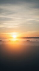Obraz premium Tranquil Sunrise Over Misty Landscape with Soft Light and Colors