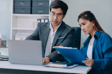 Obraz premium Millennial Asian stressed depressed worried thoughtful professional male businessman female businesswoman employee staff in formal business suit sitting thinking solving problem ideas in office room
