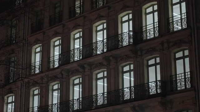 Lit windows at night Vintage building, Paris, France, Europe