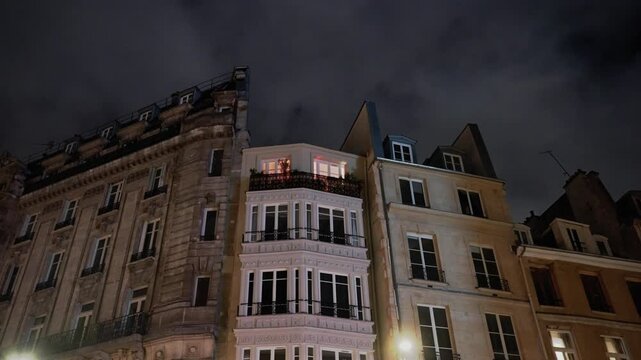 Apartment building at night Paris, France, orange light window