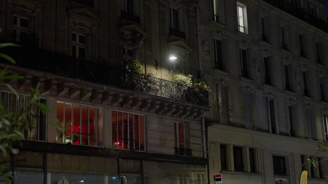 Apartment building at night with balcony, Paris, France