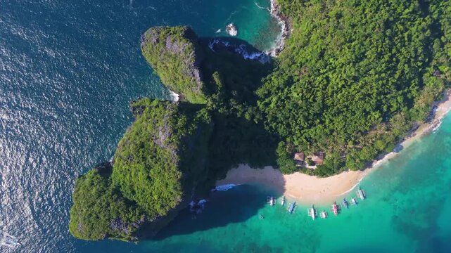 philippines aerial travel destination Cinematic drone flight over the dense tropical jungle and coastal rocks of Helicopter Island in the Bacuit Archipelago
