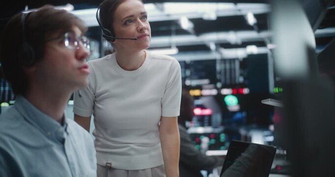 Male and Female Brokers Analyzing Real Time Stock Data Together. Two Professional Investment Experts Collaborate Closely on Trading Floor. Strategy Discussion, Data Driven Decision Making, Teamwork.