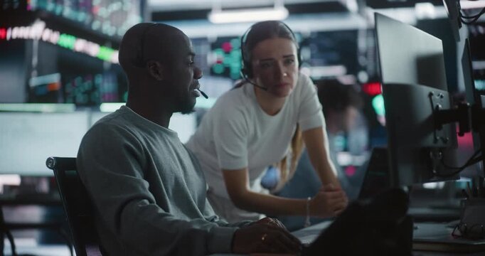 Female Financial Supervisor Mentoring Male Analyst at Stock Exchange Station. Professional Woman Providing Expert Guidance as Analyze Complex Market Data Together. Knowledge Sharing in Brokerage Firm.