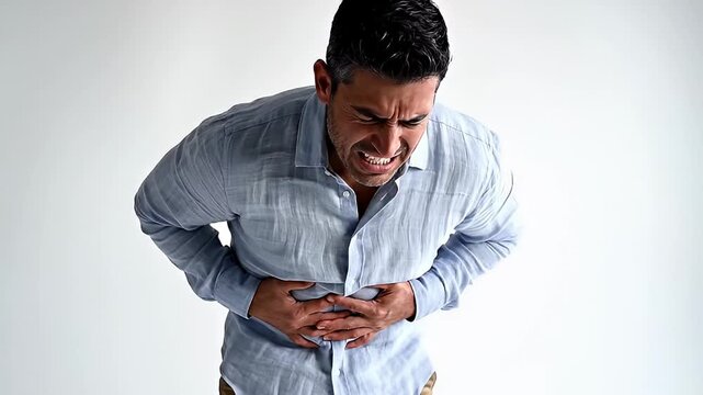 Man with severe stomach ache clutching his abdomen in pain