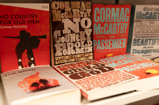 Turkey, Istanbul - 13 jan 2026. Stack of Cormac McCarthy novels on display, featuring iconic titles like No Country for Old Men and The Road in a warm bookstore setting