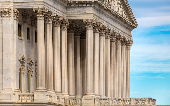 Columns architectural heritage marble exterior. Columns repetition symmetry texture. Columns decorative capitals ornament elements. Columns neoclassical structure design.
